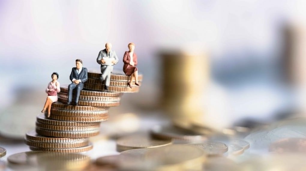 miniature people on stacked coins